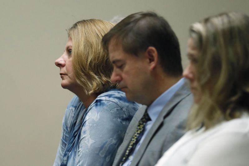 September 27, 2019 - Decatur - Kathy Olsen (left), wife of Robert Olsen, sits with family members during testimony this morning.  The murder trial of former DeKalb County Police Officer Robert "Chip" Olsen continued with testimony from prosecution witnesses this morning.  Olsen is charged with murdering war veteran Anthony Hill.  Bob Andres / robert.andres@ajc.com