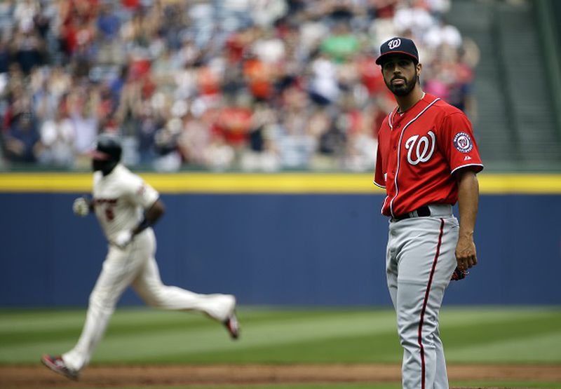 Washington Nationals starting pitcher Gio Gonzalez, right, looks toward home plate after giving up a two-run home run to Atlanta Braves' Justin Upton, left, in the first inning of a baseball game, Sunday, April 13, 2014, in Atlanta. (AP Photo/David Goldman) Gio Gonzalez contemplates another loss to Atlanta. (David Goldman/AP)