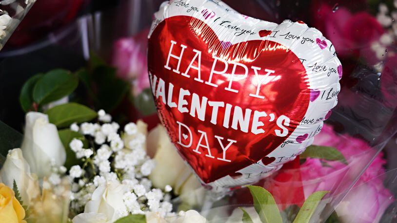 Valentine's Day balloons and flowers are sold outside a convenience store on Feb. 14, 2021, in New York City. (Cindy Ord/Getty Images/TNS)