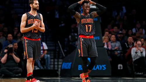 Atlanta Hawks guards Dennis Schroeder (17) and guard Jose Calderon walk back to the bench during the second half of the team’s NBA basketball game against the Brooklyn Nets on Sunday, April 2, 2017, in New York. The Nets won 91-82. (AP Photo/Adam Hunger)