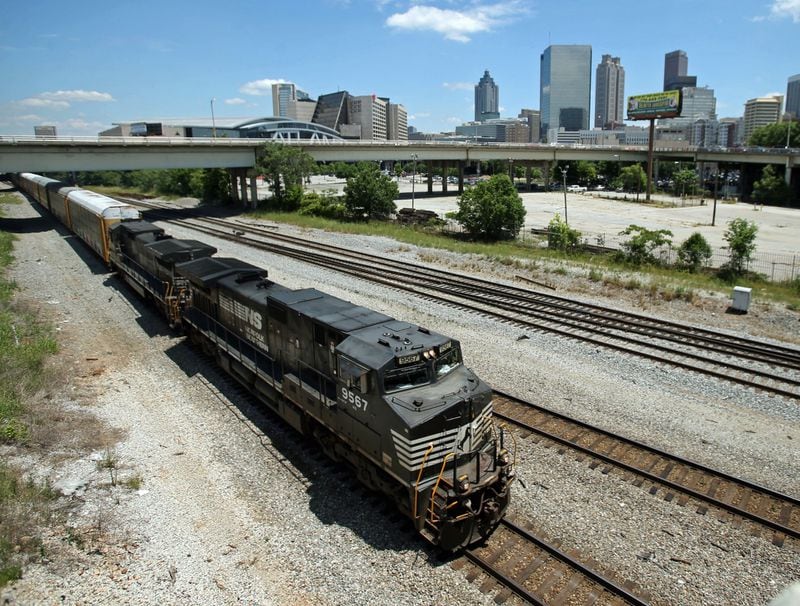 A Norfolk-Southern train travels near the Mitchell Street bridge in the downtown Atlanta’s Gulch.  JASON GETZ / JGETZ@AJC.COM