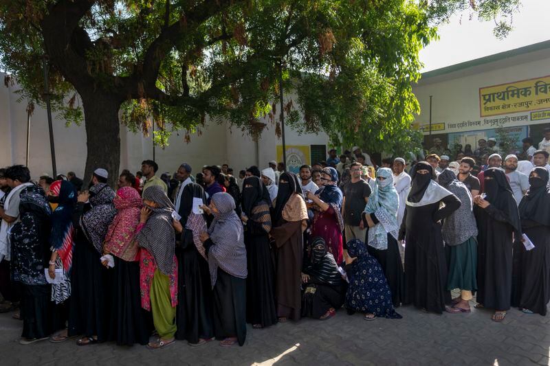 People stand in a queue to vote during the second round of voting in the six-week-long national election in Nahal village near Meerut, in Uttar Pradesh, India, Friday, April 26, 2024. (AP Photo/Altaf Qadri)