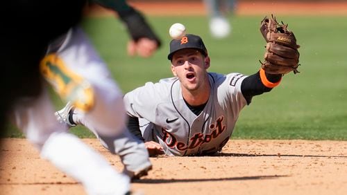 Detroit Tigers shortstop Zack Short flips the ball toward second base on an infield single hit by Oakland Athletics' Esteury Ruiz during the eighth inning of a baseball game in Oakland, Calif., Saturday, Sept. 23, 2023. (AP Photo/Jeff Chiu)