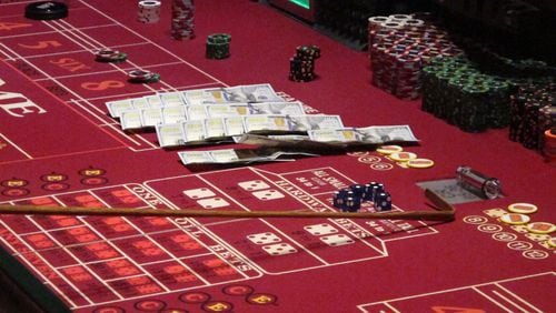 Cash, chips and dice on a craps table at a casino. AP file/Wayne Parry