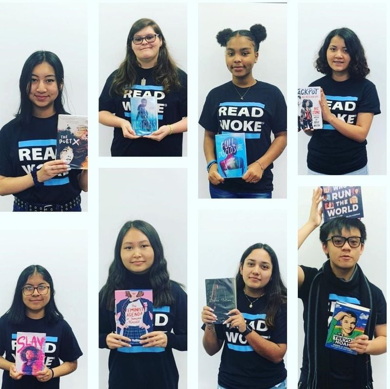 Students at Gwinnett County’s Meadowcreek High School in Norcross, show books they have read as part of Read Woke, a program developed by school librarian Cicely Lewis to encourage students to read literature that challenges social norms