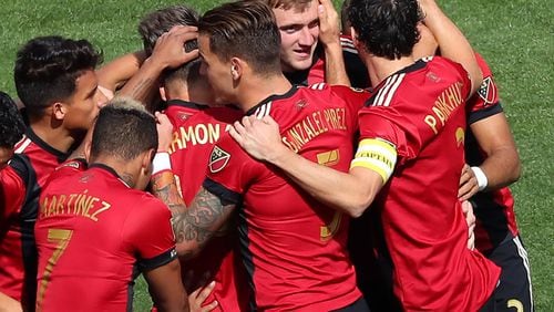 March 18, 2017, Atlanta: Atlanta United midfielder Julian Gressel is swarmed by his teammates after scoring a goal against the Chicago Fire for a 1-0 lead during the first half of their MLS game on Saturday, March 18, 2017, in Atlanta. Curtis Compton/ccompton@ajc.com