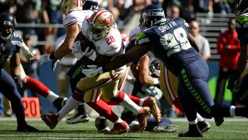Seattle Seahawks defensive tackle Garrison Smith (98) tackels San Francisco 49ers running back Carlos Hyde (28) during an NFL football game, Sunday, Sept. 25, 2016, in Seattle. (AP Photo/Ted S. Warren)