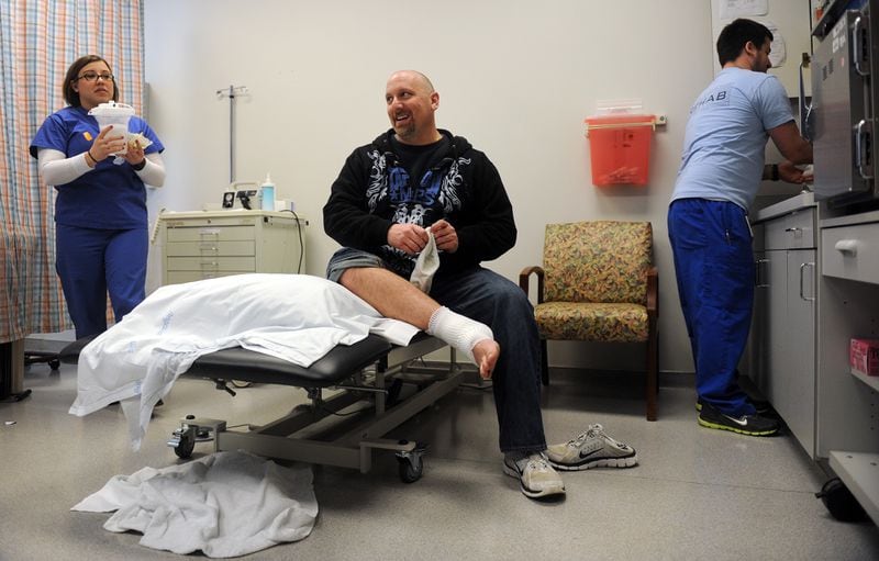 Then Det. Pat Apoian during an appointment at Northside Hospital-Forsyth on Feb. 21, 2013, nearly two years after suffering life-threatening injuries on the job. AJC photo: Bita Honarvar