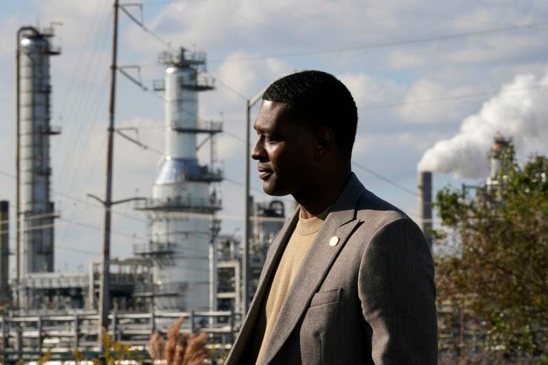 FILE - Environmental Protection Agency Administrator Michael Regan stands near the Marathon Petroleum Refinery as he conducts a television interview, while touring neighborhoods that abut the refinery, in Reserve, La., Nov. 16, 2021. More than 20 Republican attorneys general on Tuesday, April 16, 2024, asked the EPA to stop investigating environmental policies that disproportionately harm Black people but aren't intentionally discriminatory. The petition is unlikely to convince the Biden administration to back away from an issue Regan has taken pains to highlight, like visiting the industrial stretch of Louisiana typically called Cancer Alley. (AP Photo/Gerald Herbert, File)