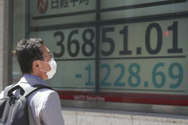 A person looks at an electronic stock board showing Japan's Nikkei 225 index at a securities firm Friday, April 19, 2024, in Tokyo. (AP Photo/Eugene Hoshiko)