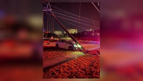 Dunwoody police shut down the Ashford Dunwoody Road bridge over Interstate 285 after a car crashed into a power pole Thursday morning. Authorities reopened the bridge Thursday afternoon.