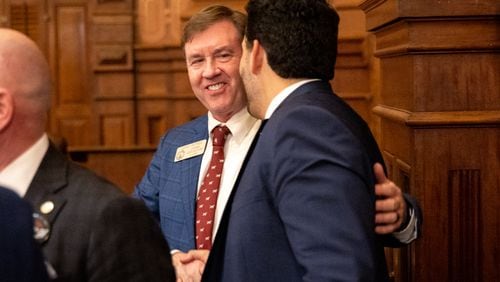 State Rep. Jesse Petrea (center), R-Savannah, is congratulated Thursday following the House's passage of his immigration bill, House Bill 1105, on Sine Die, the last day of the legislative session. The measure would require local sheriffs to work with the federal government when someone in custody is discovered to be in the country illegally. (Arvin Temkar / arvin.temkar@ajc.com)