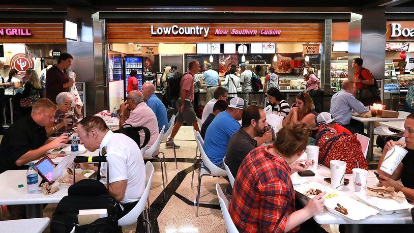 Travelers fill the dining area on Concourse A beside the Low Country restaurant at Hartsfield-Jackson International Airport on Sept 26, 2018, in Atlanta. (Curtis Compton/ccompton@ajc.com)