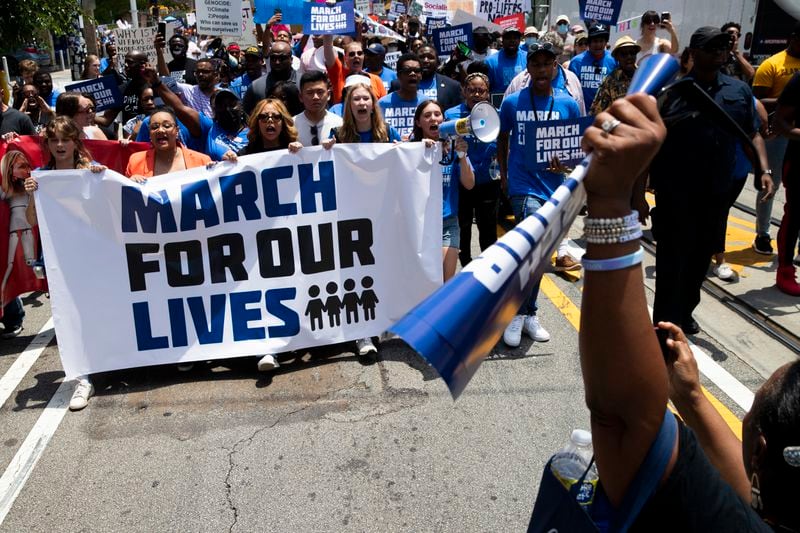 U.S. Reps. Nikema Williams and Lucy McBath hold a banner alongside event organizers during a March for Our Lives on Saturday, June 11, 2022, in Atlanta. The protesters walked from Martin Luther King Jr. National Historical Park to Woodruff Park where a rally was held. (Chris Day / Christopher.Day@ajc.com)
