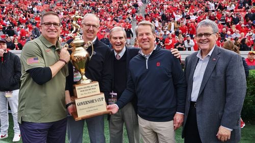 Former Children's Healthcare of Atlanta Sports Network executive director Shelton Stevens (center) poses with the Governor's Cup at a Georgia-Georgia Tech football game in Athens on Nov. 26, 2022. Stevens died in June at the age of 76. With Stevens are, from left, UGA athletic director Josh Brooks, SEC commissioner Greg Sankey, Georgia Gov. Brian Kemp and UGA President Jere Morehead. (Photo courtesy of the Stevens family).
