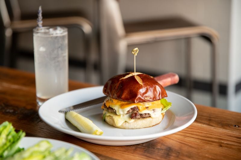 You'll probably go to Emmy Squared Pizza for their Detroit pizza, but you'll also indulge in The Big Matt, a burger with double stack grass-fed beef patties, American cheese, Sammy sauce, greens and pickles on a pretzel bun.  (Mia Yakel for The Atlanta Journal-Constitution)