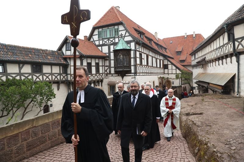 EISENACH, GERMANY - MAY 04:  Protestant clergy, led by pastor Christian Mueller, walk in a procession with a cross to an open-air church service at Wartburg Castle to commemorate the May 4, 1521, arrival of Martin Luther on May 4, 2017 in Eisenach, Germany. Luther, who is known for his 95 theses of 1517 that set the Reformation into motion, lived at Wartburg Castle under protection following his excommunication and translated the Bible there into German. Germany is celebrating the 500th anniversary of the Reformation this year with events throughout the year. The Reformation led to the creation of Protestant denominations all over the globe.  (Photo by Sean Gallup/Getty Images)