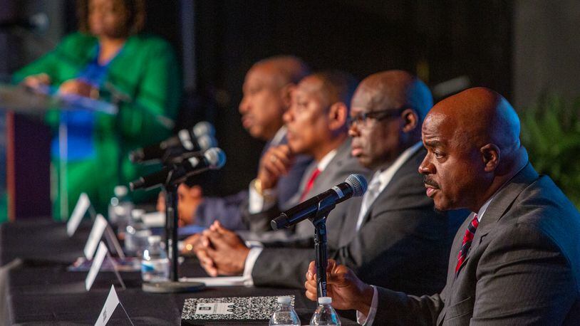 Clayton County sheriff candidates (from left) Clarence Cox, Terry Evans, Dwayne Fabian and Chris Storey debate at Tabernacle of Praise Church International in Jonesboro on Tuesday. (Jenni Girtman for Atlanta Journal-Constitution)