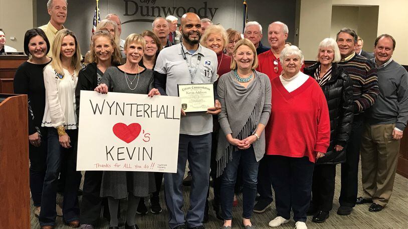 The city of Dunwoody honored mail carrier Kevin Addison (center) after he aided police in catching an identify fraud suspect.