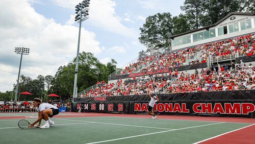 Georgia's Teodor Giusca serves as doubles teammate Phillip Henning crouches near the net as the No. 6 Bulldogs took on No. 11 Harvard in a NCAA Tennis Super Regional matchup Saturday at Henry Feild Stadium inside the Dan Magill Tennis Complex. (Tony Walsh/UGA Athletics)