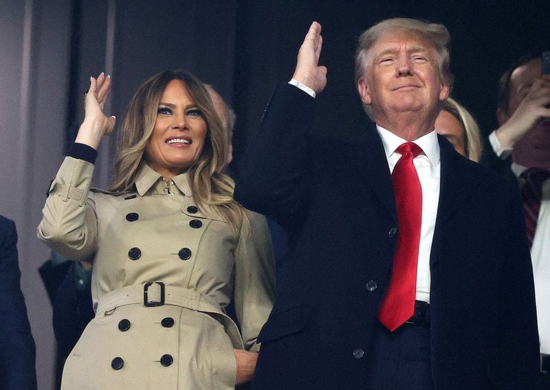 Former first lady Melania Trump and President Donald Trump do the Tomahawk Chop prior to Game 4 of the World Series between the Houston Astros and the Atlanta Braves at Truist Park on Saturday, Oct. 30, 2021, in Atlanta. Melania Trump is getting into NFTs. (Elsa/Getty Images/TNS)