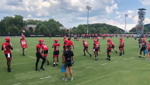 Receivers coach Cortez Hankton (center) is hard to spot among his 18 charges as they run through drills on Woodruff Practice Fields during preseason camp on the UGA campus in Athens this past weekend.