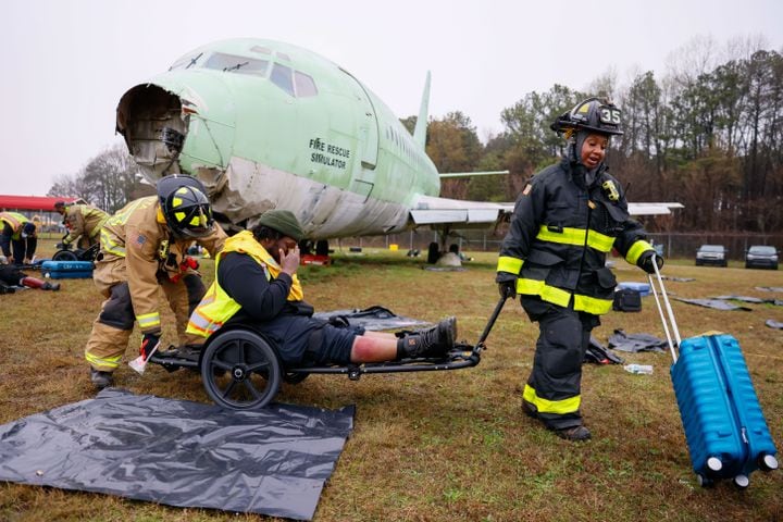 Firefighters transport a fake victim in a wheelchair as Hartsfield-Jackson International Airport held a full-scale disaster drill with Atlanta Firefighters, law enforcement, rescue personnel, and nearly 70 volunteers who participated in a triennial exercise known as “Big Bird” on Wednesday, March 6, 2024.
Miguel Martinez /miguel.martinezjimenez@ajc.com