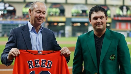 Houston Astros owner Jim Crane presents 2018 Masters winner Patrick Reed with a jersey before the game between Texas Rangers and Houston Astros Saturday, April 14, 2018, at Minute Maid Park in Houston.