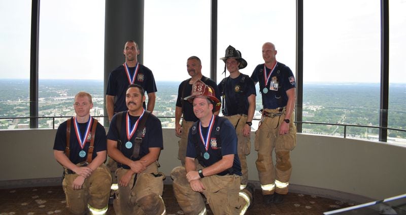 DeKalb County firefighters gather after climbing 72 flights of stairs at the Westin Peachtree Plaza.