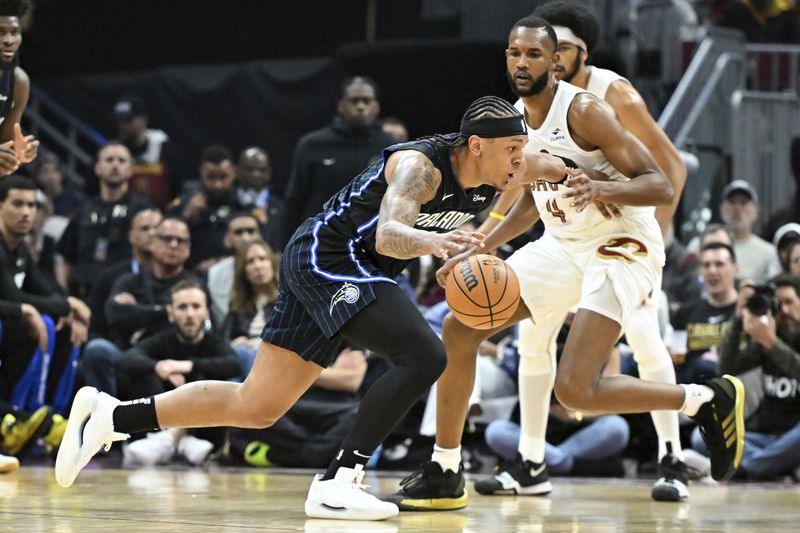 Orlando Magic's Paolo Banchero drives against Cleveland Cavaliers' Evan Mobley (4) during the first half in Game 1 of an NBA basketball first-round playoff series, Saturday, April 20, 2024, in Cleveland. (AP Photo/Nick Cammett)