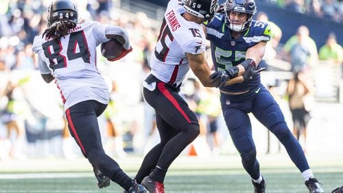 Seattle's Cody Barton is taken out of the play by Atlanta's Feleipe Franks, giving Cordarrelle Patterson room to run for 18 yards in the third quarter Sunday at Lumen Field in Seattle. (Dean Rutz/The Seattle Times/TNS)