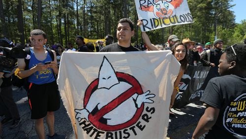 A protester holds a banner while marching against a white power rally at Stone Mountain Park on April 23, 2016. A white power rally and two counter-protests took place at the park at the time. Ben Gray / bgray@ajc.com