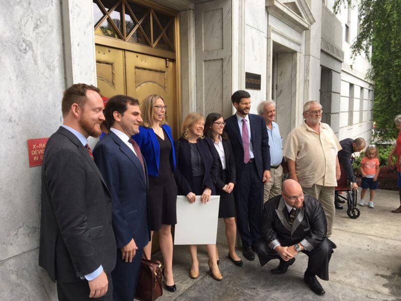  The Undisclosed legal team and others, after the Georgia Supreme Court arguments. (from left, lawyers Brandon Waddell and Michael Caplan; Susan Simpson of Undisclosed; Clare Gilbert of the Georgia Innocence Project and lawyers Sarah Brewerton-Palmer; James Cobb, who argued the case; Carl Greenberg; and Terry Wanzer. Justin Chapman is squatting in front.)
