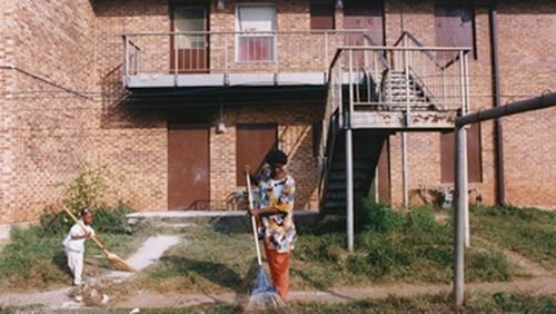 Rilene and Chasity Dixon clean up the lawn in front of their East Lake Meadows apartment. Atlanta, GA. October 28, 1992. (Credit:PBS)