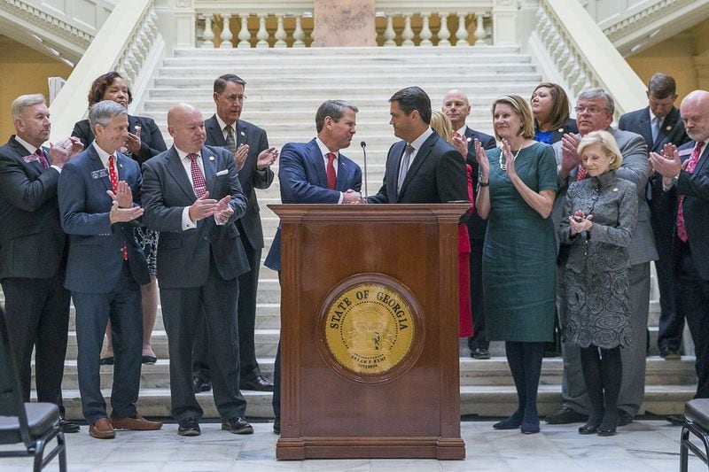 Georgia Lt. Gov. Geoff Duncan (right) shakes Gov. Brian Kemp’s hand after introducing him during a press conference at the State Capitol Nov. 4, 2019. Gov. Kemp announced a proposed limited expansion of Medicaid in Georgia. (Alyssa Pointer/Atlanta Journal-Constitution)