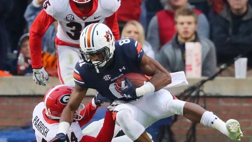 Auburn wide receiver Darius Slayton makes a touchdown catch in front of Georgia defenders Malkom Parrish and Aaron Davis to take a 16-7 lead during the second quarter on Saturday, Nov. 11, 2017. (Curtis Compton/Atlanta Journal-Constitution/TNS)