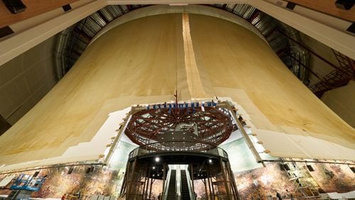 This photo shows an exterior view of the panoramic painting “The Battle of Atlanta” taken early in the restoration process. It reveals the hyperbolic shape of the painting when hung correctly. At the center is an escalator that will take visitors to the viewing platform. The diorama around the base of the painting had not yet been installed.CONTRIBUTED BY THE ATLANTA HISTORY CENTER