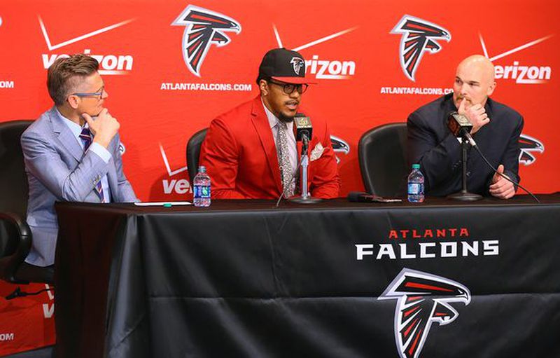Falcons general manager Thomas Dimitroff (left) and coach Dan Quinn look on as first-round draft pick Vic Beasley takes questions from the media during his news conference at the team's training facility in Flowery Branch. (Curtis Compton / ccompton@ajc.com)