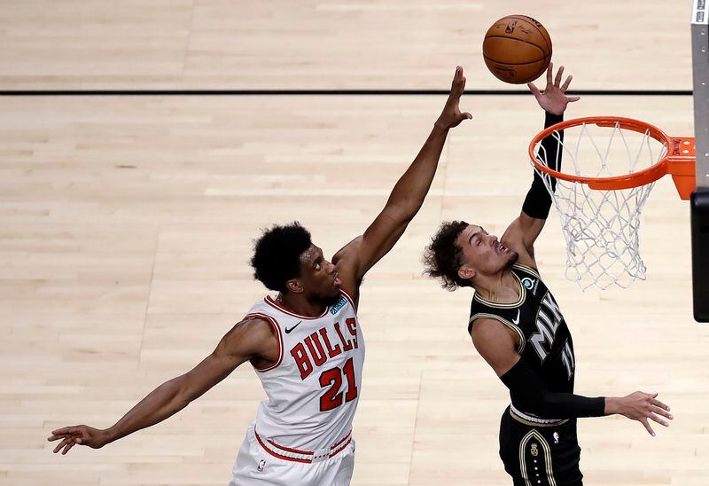 Atlanta Hawks' Trae Young, right, lays up a shot past Chicago Bulls' Thaddeus Young (21) during the first half of an NBA basketball game Friday, April 9, 2021, in Atlanta. (AP Photo/Ben Margot)