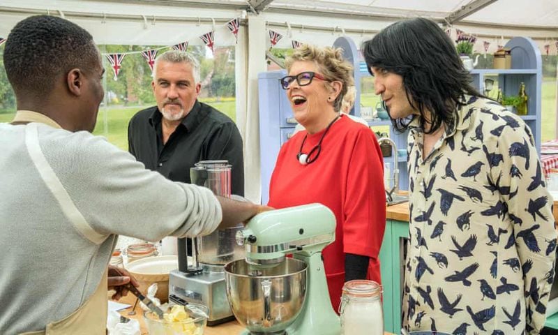 Liam Charles (left), a 2017 contestant, chats with judges Paul Hollywood and Prue Leith and “Great British Baking Show” host Noel Fielding. (Courtesy of Channel 4)