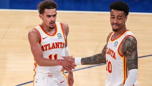 Atlanta Hawks guard Trae Young (11) and forward John Collins (20) congratulate each other after defeating the New York Knicks 103-89 in Game 5 of an NBA basketball first-round playoff series Wednesday, June 2, 2021, in New York. (Wendell Cruz/Pool Photo via AP)