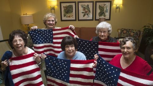 Nancy Harvey (from left), Rose Marie Holbein, Olive Ellner, Marjory Everett and Esther Solomon show American flag lap quilts that they knitted at Huntcliff Summit, an independent living facility in Sandy Springs, for wounded veterans in wheelchairs. The idea was originally Ellner’s (center), who said, “I had to find something to do for somebody that was meaningful.” Before this project, 90 year-old Ellner says that she hadn’t knitted in 50 years. CASEY SYKES / CASEY.SYKES@AJC.COM