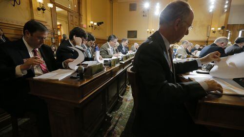 Georgia House Appropriations Committee members read through the tracking sheet for the fiscal 2018 state budget Thursday before voting to approve the $25 billion spending plan. BOB ANDRES / BANDRES@AJC.COM