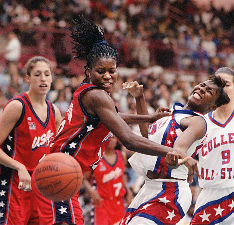 USA's #12 Katrina McClain, left, collides with WBCA's Michi Atkins Saturday at Morehouse College Arena. The USA Basketball women's team played the WBCA College All-Stars. The USA team won, 92-57. (AJC Photo/Joey Ivansco) 4/96