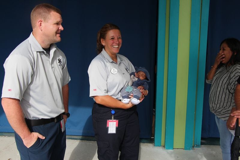 The woman who gave birth at Six Flags Over Georgia in July reunites with the paramedics who helped her with the unexpected theme park birthing on Friday, Sept. 28, 2018. (Six Flags Over Georgia)