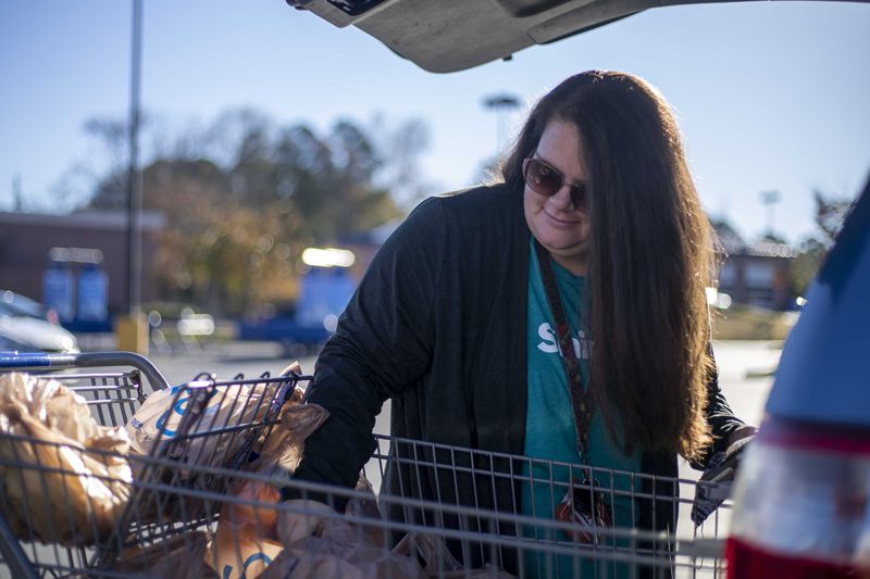 Shopper April Wright loads groceries into her car for a customer in Canton. Wright has been working with shop-and-deliver company Shipt for almost 3 years. The coronavirus pandemic caused a massive surge in online grocery shopping.  (Alyssa Pointer / Alyssa.Pointer@ajc.com)