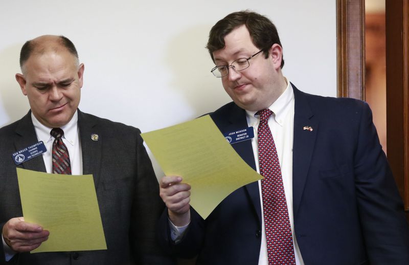 RESOLUTION READING--Then-Sen. Josh McKoon and his colleague Bruce Thompson review a draft of "religious liberty" legislation in 2016. Thompson is now the state's labor commissioner. BOB ANDRES / BANDRES@AJC.COM
