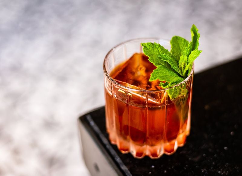 The Two World Hero cocktail at By George is a spin on a Vieux Carré featuring black tea-infused cognac. CONTRIBUTED BY HENRI HOLLIS
