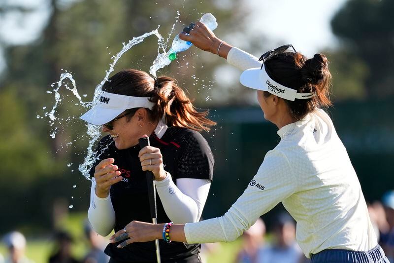 Grace Kim, right, sprays water on Hannah Green after Green won the LPGA's JM Eagle LA Championship golf tournament at Wilshire Country Club, Sunday, April 28, 2024, in Los Angeles. (AP Photo/Ashley Landis)