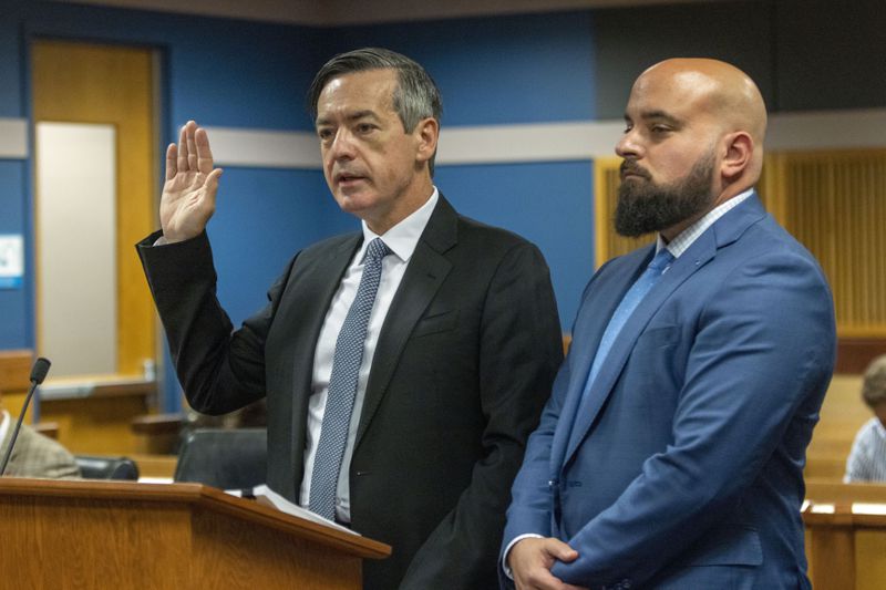 Attorney Scott Grubman, right, stands with his client, Kenneth Chesebro as Chesebro is sworn in during a plea deal hearing, Friday, Oct. 20, 2023, at the Fulton County Courthouse in Atlanta. (Alyssa Pointer/Pool Photo via AP)